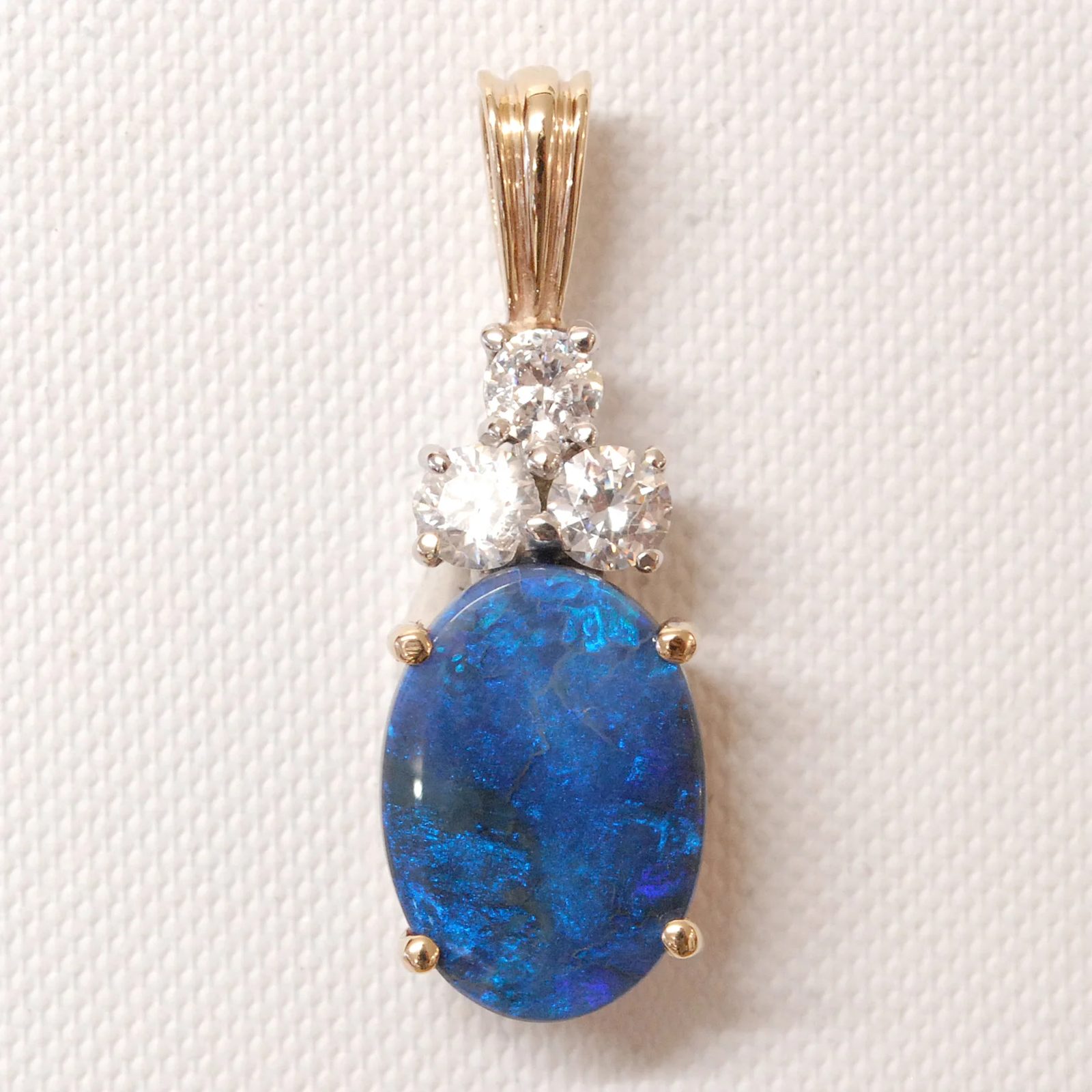 Oval opal triplet and white sapphires, reset as a pendant.